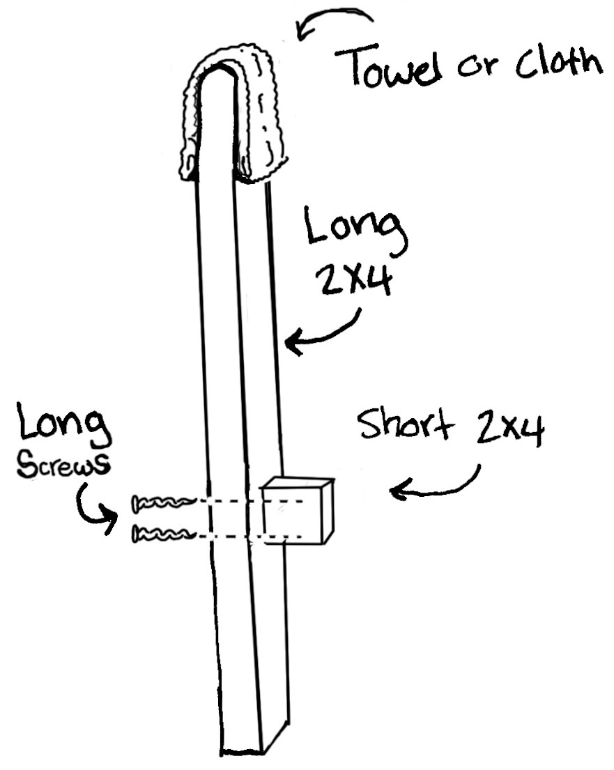 A long 2x4 with a towel or cloth over the end and a short 2x4 attached toward the bottom.